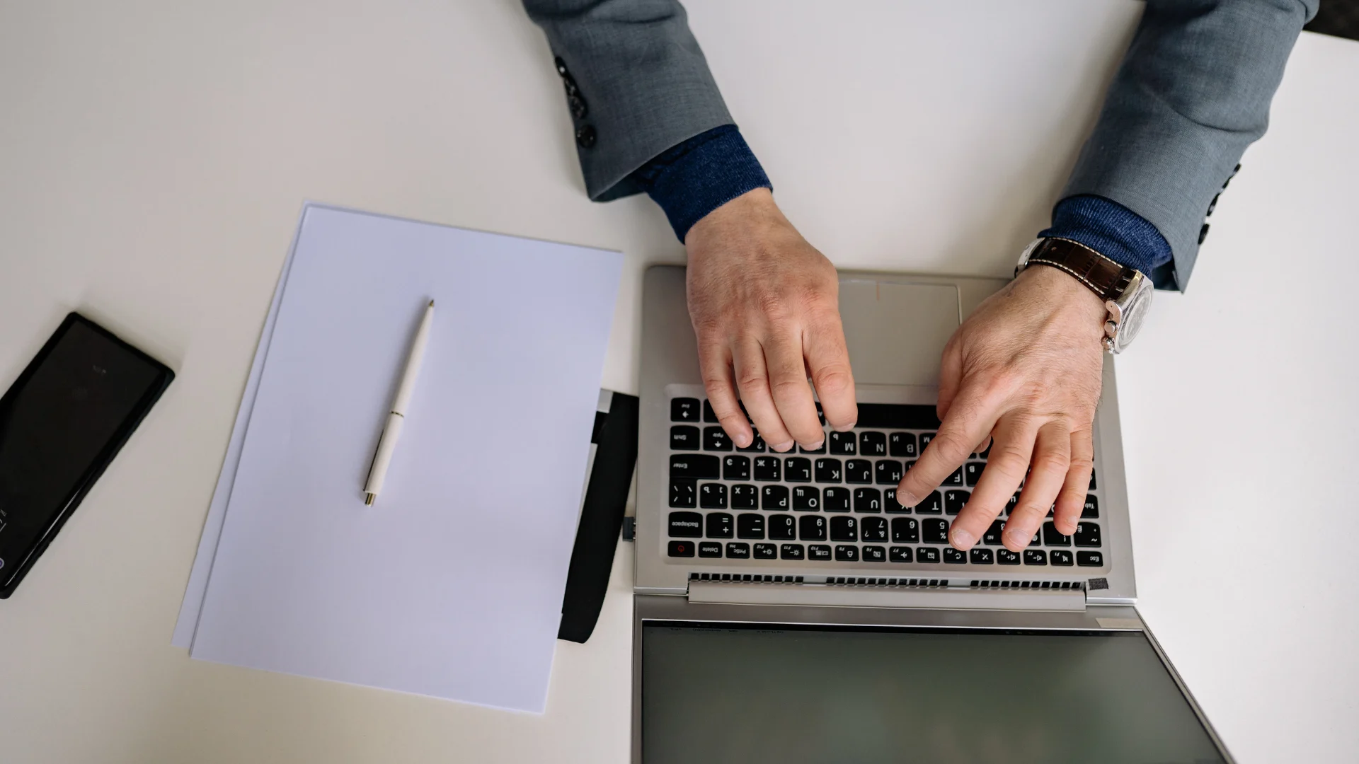 Person working on laptop researching online side hustles that pay fast