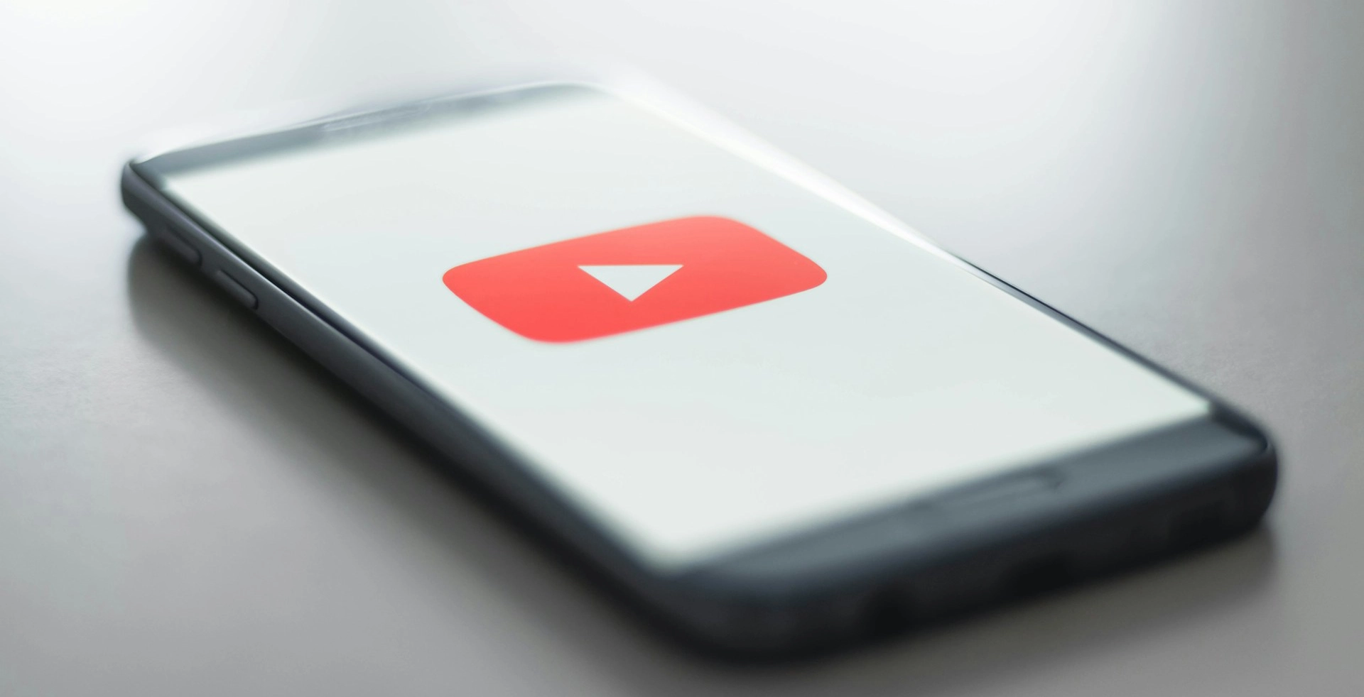 Smartphone displaying the YouTube logo on its screen.
