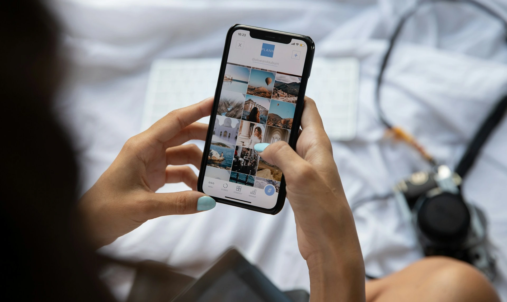 Person browsing a grid of travel photos on a smartphone.