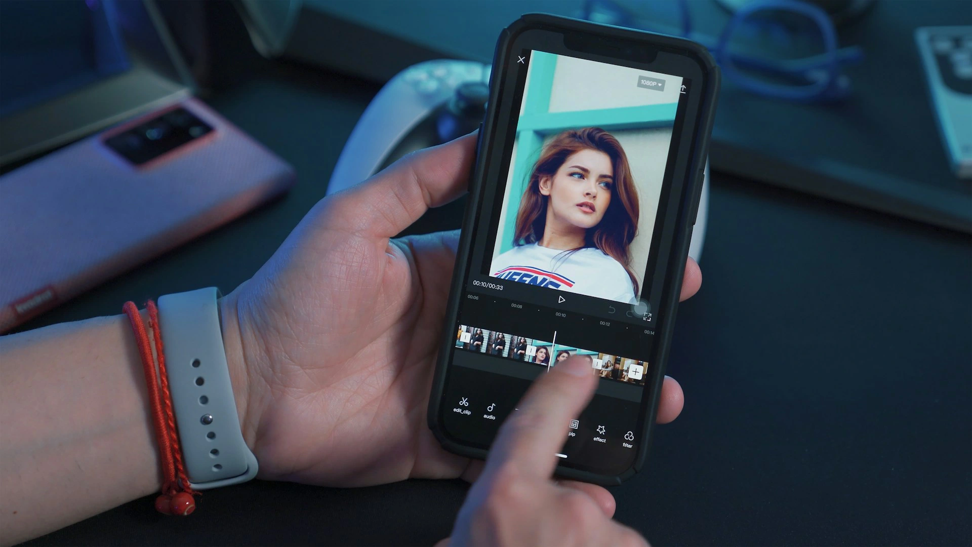 Hand holds smartphone displaying video editing app with a portrait of a woman.vvvvvvvvvvvvvvvvvvvvvvvvvvvvvvvvvvvvvvvvvvvvvvv